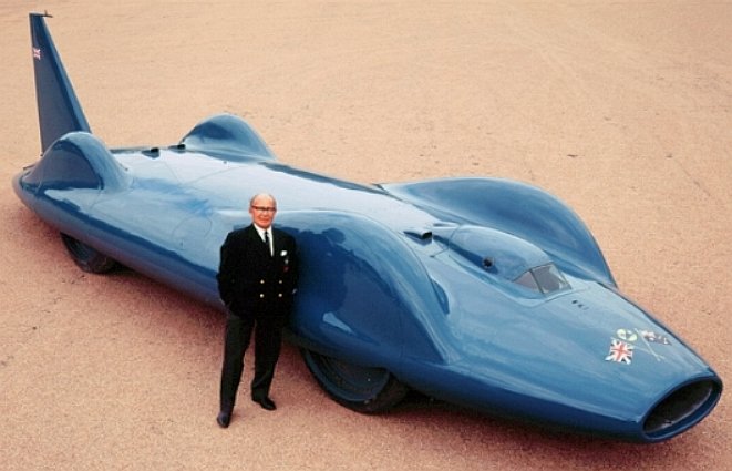 Leo Villa standing beside the CN7 jet LSR car of Donald Campbell