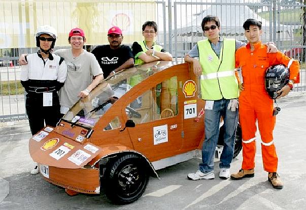 Wooden electric eco car with driver and team members
