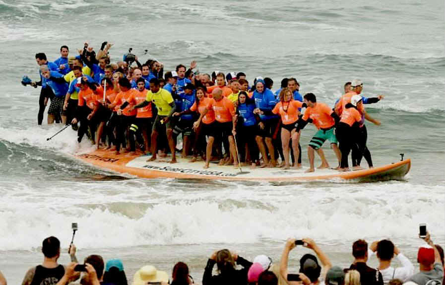 66 surfers in California set a new world record on a giant board