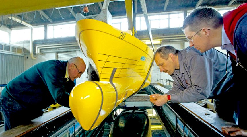 A model of Titanic 2 is lowered into a tow tank basin