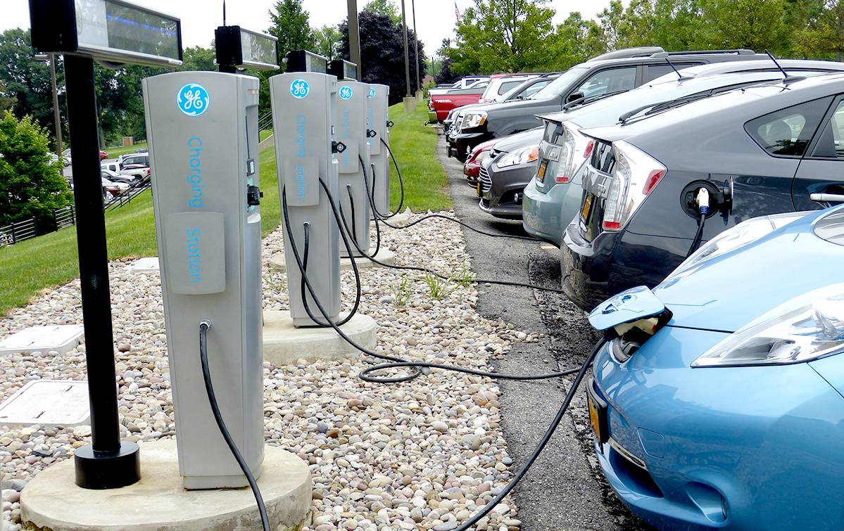 Park and charge plug in bays for electric vehicles