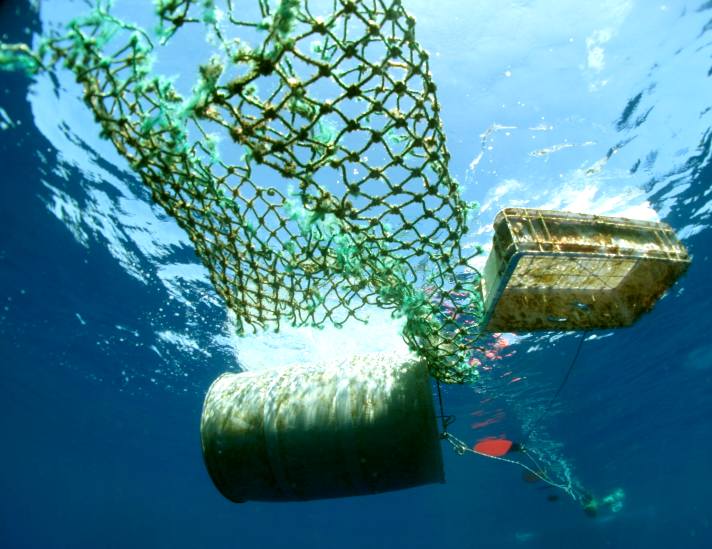Ocean waste, ol drum, plastic crate and fishing nets