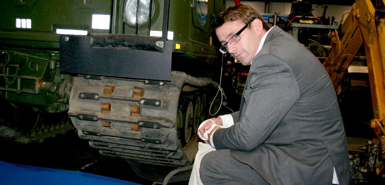 Chris Close studying a rubber caterpillar tracked vehicle
