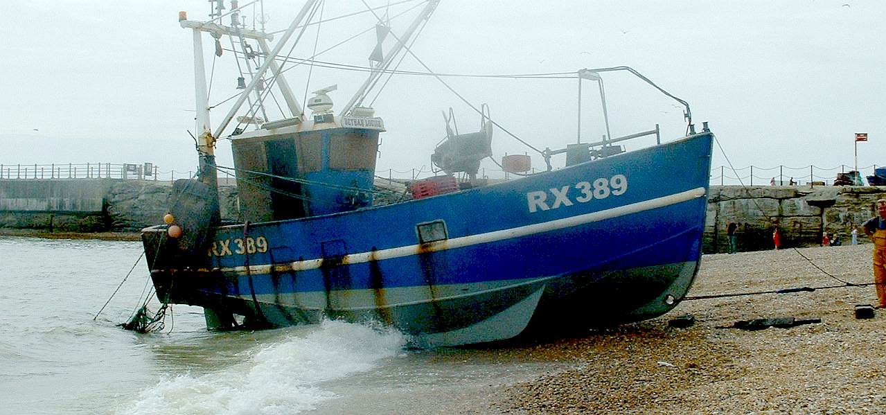 A fishing boat while being pulled up the beach at Hastings in Sussex