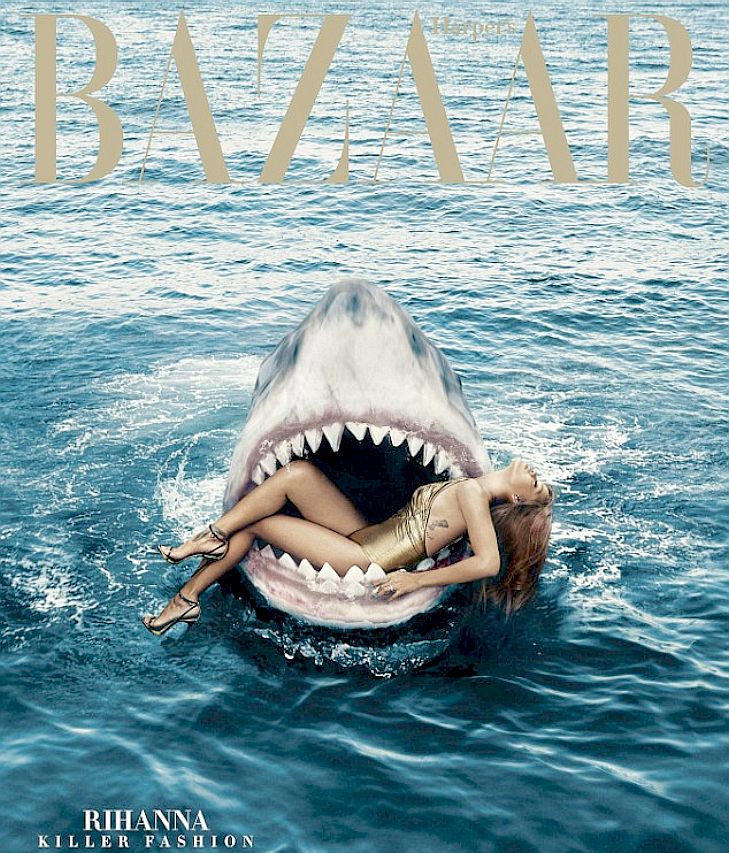 Rihanna sits in the mouth of a massive great white shark